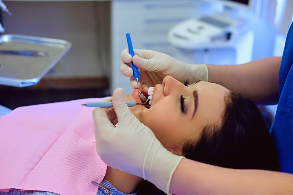 Dentist assessing a patient before teeth whitening